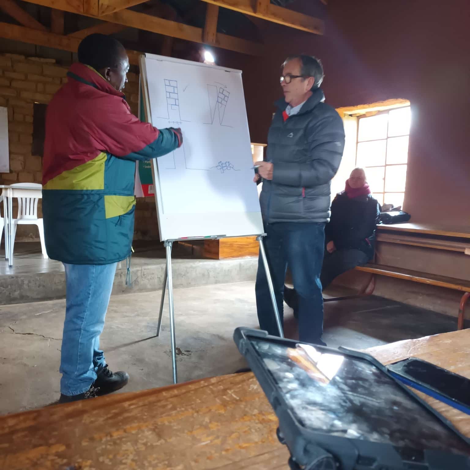Community members collaborating on heritage conservation planning at a whiteboard session
