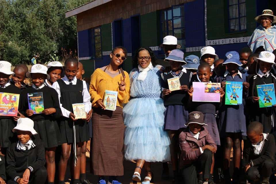 School children with teachers holding published Sesotho storybooks