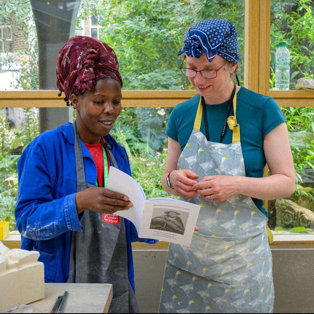Maneo Sekata and colleague reviewing conservation documentation